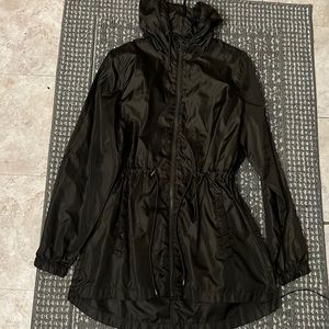 Green wind breaker with pocket on back and hood